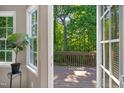 A lovely view to the wooden deck is shown through open french doors at 7019 Bellard Ct, Raleigh, NC 27617