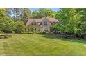 Stately home with a lush, green lawn and mature landscaping at 7212 Donneeford Rd, Wake Forest, NC 27587