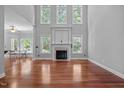 Bright living room boasting tall windows, a fireplace, and hardwood floors, perfect for entertaining at 7212 Donneeford Rd, Wake Forest, NC 27587