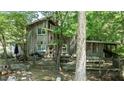 Charming wood-sided home featuring a large wooden deck and mature trees at 82 Deercorn Path, Moncure, NC 27559