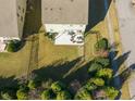 An aerial view of a well-maintained, fenced backyard with a patio and lawn at 901 Lemongrass Ln, Wake Forest, NC 27587