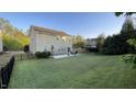 Spacious backyard with a patio, furniture, and a fence surrounding the lawn, perfect for outdoor activities at 901 Lemongrass Ln, Wake Forest, NC 27587