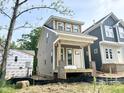 New construction home with gray siding and unfinished landscaping at 901 Linwood Ave, Durham, NC 27701