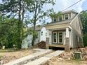 New construction home with a charming craftsman style, featuring a covered front porch and gray siding at 901 Linwood Ave, Durham, NC 27701