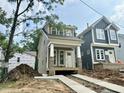 Exterior view of a new construction home with gray siding and a welcoming covered front porch at 901 Linwood Ave, Durham, NC 27701