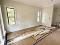 Bright living room with large windows and crisp white trim, awaiting your personal touch at 901 Linwood Ave, Durham, NC 27701