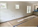 Bright, unfinished living room with large windows allowing ample natural light at 903 Linwood Ave, Durham, NC 27701