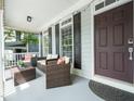 Inviting covered porch featuring cozy wicker furniture and stylish decorative accents at 915 Edgewater Cir, Chapel Hill, NC 27516