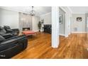 Modern living room boasts a cozy fireplace and gleaming hardwood floors at 915 Edgewater Cir, Chapel Hill, NC 27516