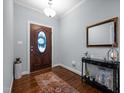 Welcoming entryway with hardwood floors, decorative mirror and stylish console table at 928 Arrowhead Ln, Mebane, NC 27302