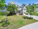 Beautiful home with a manicured lawn, mature trees, and inviting curb appeal at 948 Uprock Dr, Cary, NC 27519