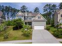 Beautiful two-story home featuring a manicured lawn, attached garage and mature trees in a desirable neighborhood at 948 Uprock Dr, Cary, NC 27519