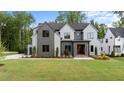 Beautiful modern two-story home with lush green lawn, professional landscaping, and stylish curb appeal at 949 Harrison Ridge Rd, Wake Forest, NC 27587