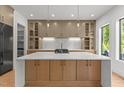Bright kitchen island with quartz countertop, cabinet storage, and overhead pendant lighting at 949 Harrison Ridge Rd, Wake Forest, NC 27587