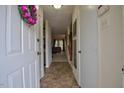 Hallway featuring tile flooring and neutral walls with a view into the living area at 10 Grove Park Rd, Durham, NC 27705