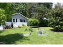 Expansive backyard featuring a raised garden, lush lawn, and privacy landscaping at 1004 Greenwich St, Raleigh, NC 27610
