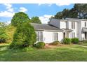 Neat townhome with well-manicured lawn and lush greenery at 101 Pickett Ln, Cary, NC 27511