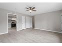Open living space featuring wood-look floors, neutral walls, and a view into the adjacent kitchen at 1100 Pecan Pl, Durham, NC 27704