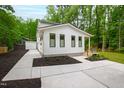 Charming two-story home with a well-manicured lawn and walkway to the main entrance at 112 Meadowbrook Dr, Chapel Hill, NC 27514