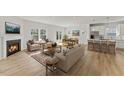 Open-concept living room with fireplace, modern kitchen, and plenty of natural light at 121 Cribbs Ln, Middlesex, NC 27557