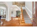 Grand foyer with a curved staircase, hardwood floors, and elegant architectural details at 12428 Penrose Trl, Raleigh, NC 27614