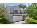 Beautiful two-story home featuring a garage and inviting front porch at 1302 Ingle Ct, Burlington, NC 27215