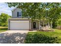 Inviting two-story home with a spacious garage and quaint front porch swing at 1302 Ingle Ct, Burlington, NC 27215