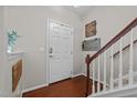 Welcoming foyer with hardwood floors, a staircase, and a front door at 1302 Ingle Ct, Burlington, NC 27215