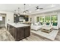 Open-concept living space features a large island and modern finishes at 1609 Garden Park Cir, Fuquay Varina, NC 27526