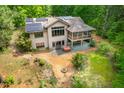 Aerial view of the home featuring solar panels, screened-in porch, and a hot tub at 201 Summergate Cir, Chapel Hill, NC 27516