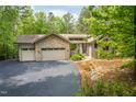 Home exterior showcasing stone accents, a two-car garage, and an extended driveway at 201 Summergate Cir, Chapel Hill, NC 27516