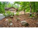Stone and siding home nestled amongst the trees at 201 Summergate Cir, Chapel Hill, NC 27516