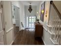 Inviting foyer with hardwood floors, decorative chandelier, and staircase at 202 Selkirk Pl, Durham, NC 27707