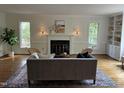 Bright living room with hardwood floors, fireplace, built-in shelves, and ample natural light at 202 Selkirk Pl, Durham, NC 27707