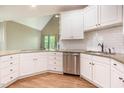 Bright kitchen features granite countertops, white cabinets, and stainless-steel appliances at 216 Billingrath Turn Ln, Cary, NC 27519