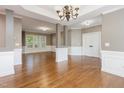 Spacious living room with gleaming hardwood floors and elegant chandelier at 216 Billingrath Turn Ln, Cary, NC 27519