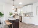 Open kitchen boasts stainless steel appliances, granite countertops and an island with barstool seating at 2581 Green Valley Blvd, Burlington, NC 27217