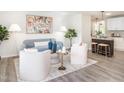 Cozy living room with light blue sofa and adjacent island with barstool seating in the kitchen at 2581 Green Valley Blvd, Burlington, NC 27217