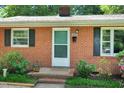 Inviting brick home entrance with a welcoming front door and manicured landscaping at 2709 Farthing St, Durham, NC 27704