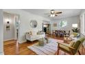 Bright living room featuring hardwood floors, a ceiling fan, and abundant natural light at 2709 Farthing St, Durham, NC 27704