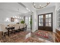 Elegant dining room featuring hardwood floors, stylish lighting, and french doors, perfect for entertaining guests at 2908 Stubble Field Dr, Raleigh, NC 27613
