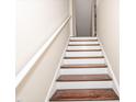 Staircase view with white risers and dark wood treads at 3000 Summerhouse Rd, Cary, NC 27519