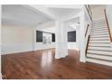 Spacious living room showcasing gleaming hardwood floors, decorative trim, and lots of natural light at 311 Windrush Ln, Durham, NC 27703