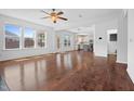 Bright and airy living room featuring hardwood floors and seamless access to the kitchen and outdoor spaces at 311 Windrush Ln, Durham, NC 27703