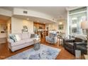 Cozy living room showcasing hardwood floors, comfortable seating, and an open layout connected to the kitchen at 3210 Environ Way, Chapel Hill, NC 27517