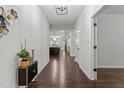 Inviting hallway with hardwood floors, leading to an open-concept living space at 323 Oak Branch Trl, Garner, NC 27529