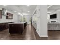 Modern kitchen with granite countertops, stainless steel appliances, and a large island at 323 Oak Branch Trl, Garner, NC 27529