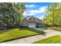 A well-maintained home with brick and stone accents, a spacious yard, and a convenient two-car garage at 3824 Laurel Hills Rd, Raleigh, NC 27612