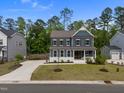 Stately two-story home with a well-groomed lawn, spacious driveway, and beautiful blue facade at 3866 Keohane Dr, Durham, NC 27705