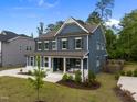 Attractive two-story home featuring a manicured lawn, attached garage, and charming blue siding at 3866 Keohane Dr, Durham, NC 27705